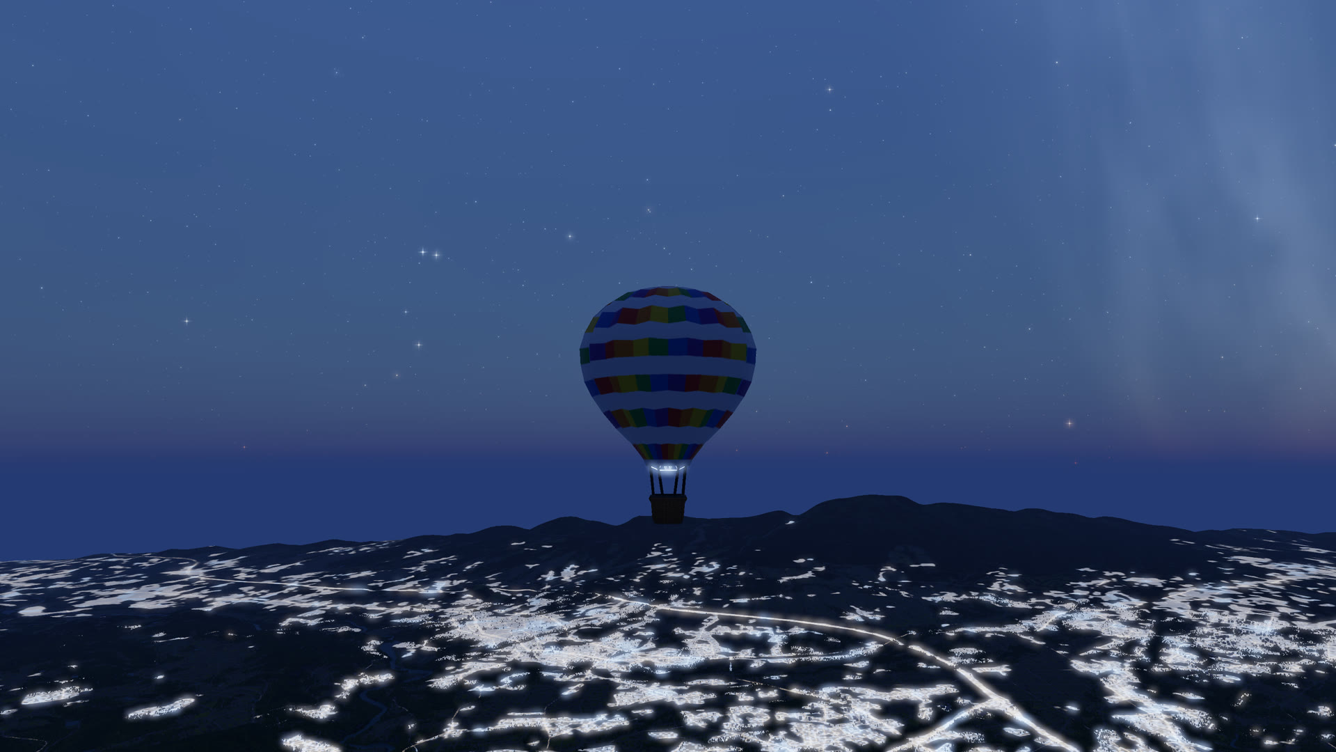 A balloon under a starry sky above scattered town lights